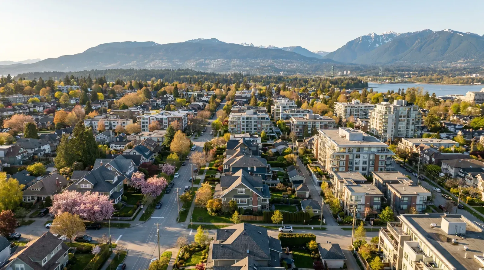 Aerial view of Vancouver neighbourhoods from Mount Pleasant to the West End with mountains in the background