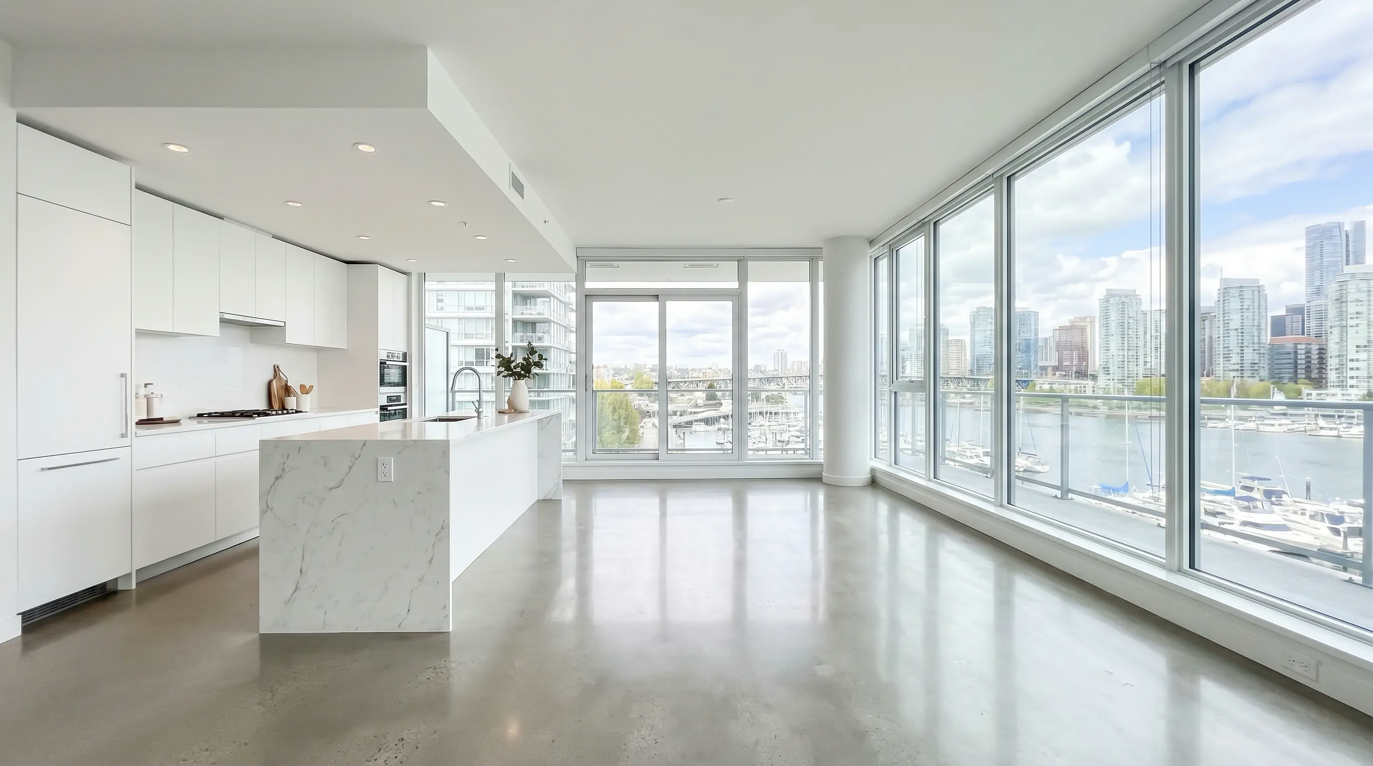 Empty modern Vancouver presale condo show suite with marble waterfall island and floor-to-ceiling windows showing False Creek